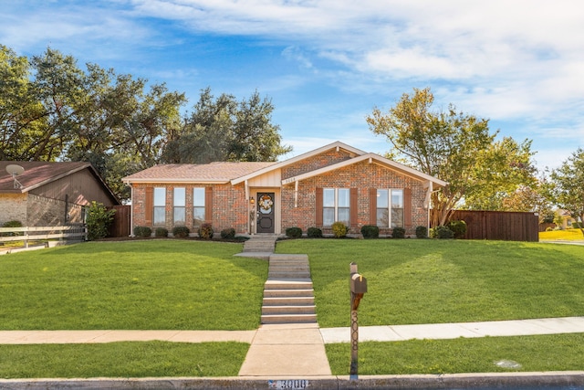 single story home featuring a front lawn