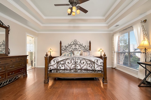 bedroom featuring a tray ceiling, ceiling fan, and crown molding