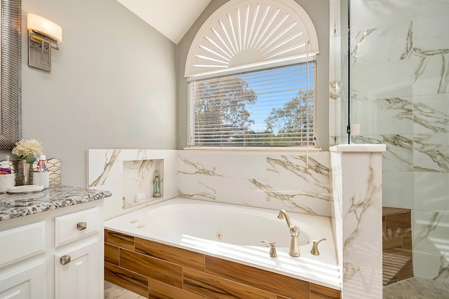 bathroom featuring vanity, separate shower and tub, and vaulted ceiling