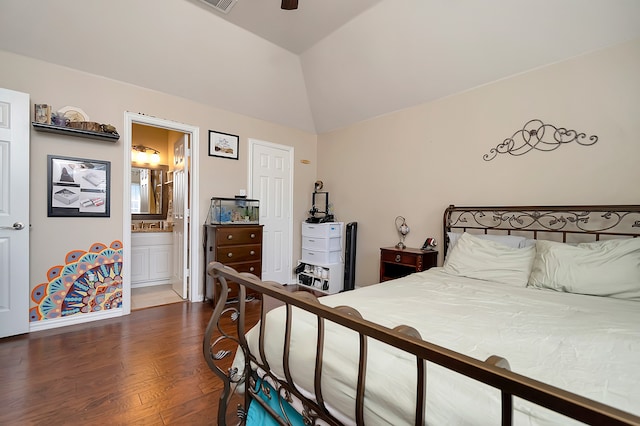 bedroom featuring dark hardwood / wood-style flooring, ensuite bathroom, vaulted ceiling, and ceiling fan