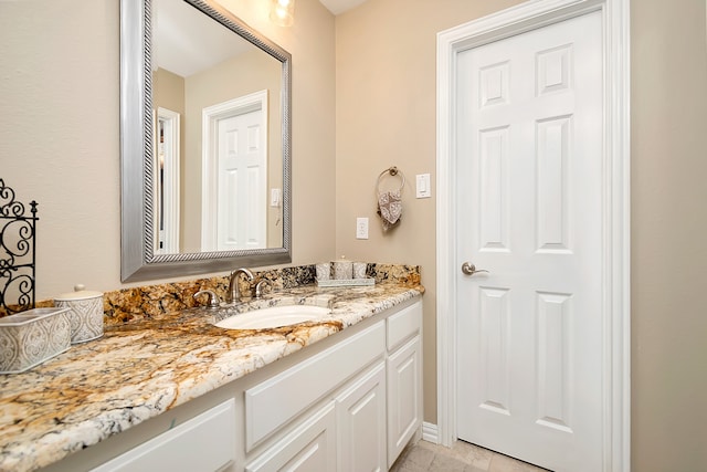 bathroom featuring tile patterned flooring and vanity