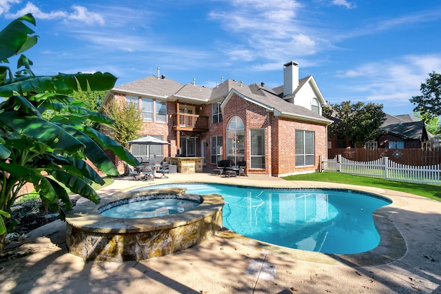 view of pool featuring an in ground hot tub and a patio