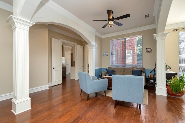 living room with crown molding, dark hardwood / wood-style flooring, and ceiling fan