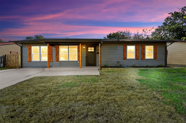 ranch-style home with a yard