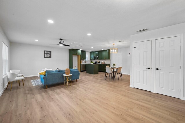 living room featuring light hardwood / wood-style flooring and ceiling fan