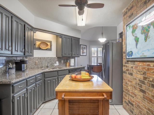 kitchen with gray cabinetry, a textured ceiling, stainless steel appliances, ceiling fan, and sink