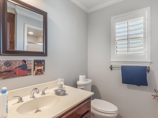 bathroom featuring vanity, toilet, and ornamental molding