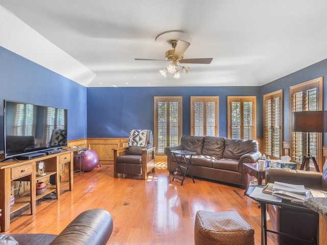 living room featuring ceiling fan and light hardwood / wood-style flooring