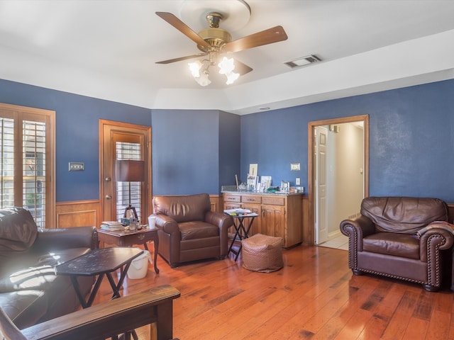 living room with ceiling fan and hardwood / wood-style floors