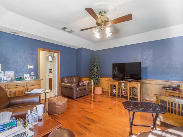 living room with hardwood / wood-style flooring and ceiling fan