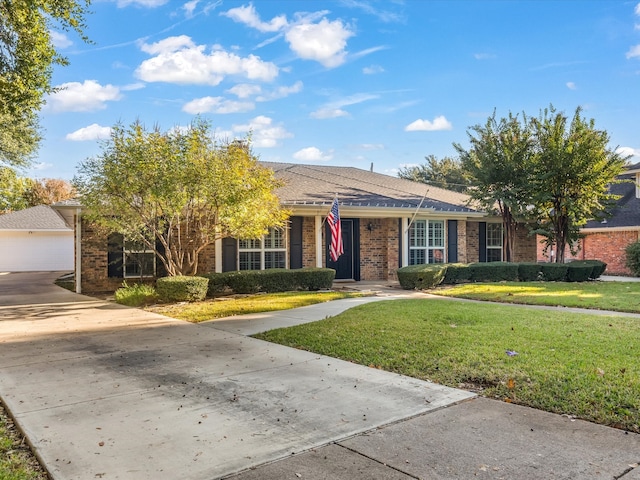 view of front of home with a garage and a front lawn