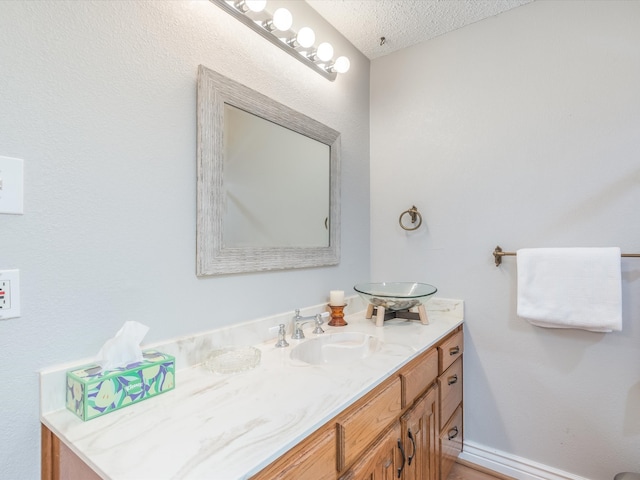 bathroom with vanity and a textured ceiling