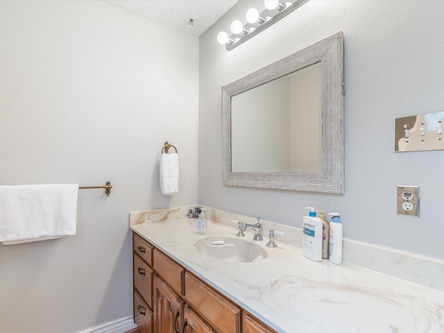 bathroom with vanity and a textured ceiling