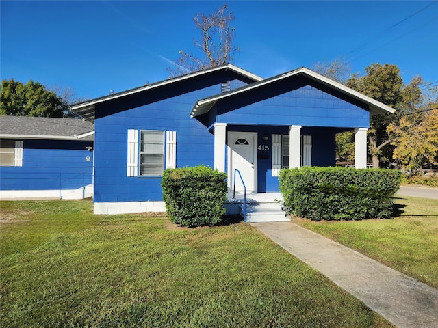 bungalow-style home with a front lawn