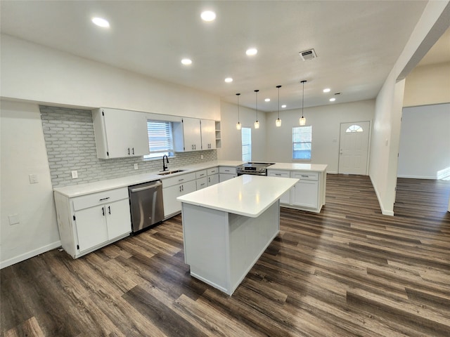 kitchen with appliances with stainless steel finishes, a center island, dark hardwood / wood-style floors, and sink