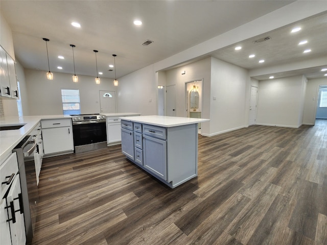 kitchen with pendant lighting, dark wood-type flooring, white cabinets, kitchen peninsula, and stainless steel appliances