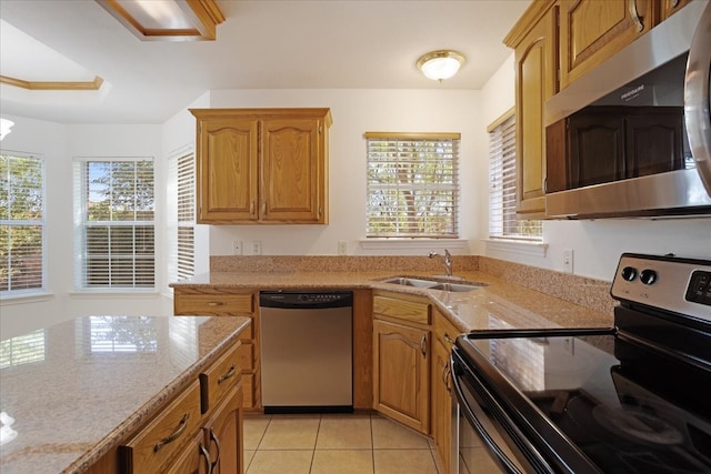 kitchen with light stone countertops, sink, stainless steel appliances, a notable chandelier, and light tile patterned floors