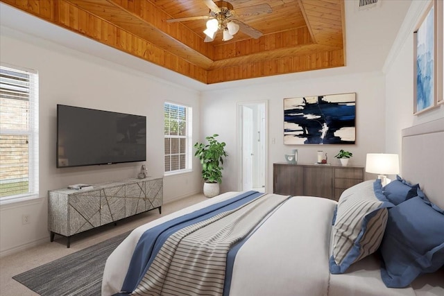 bedroom with a tray ceiling, wooden ceiling, ceiling fan, and carpet flooring