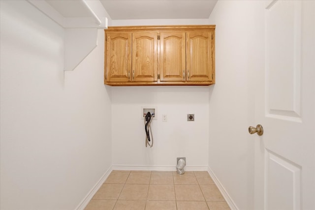 washroom featuring cabinets, light tile patterned floors, washer hookup, and hookup for an electric dryer