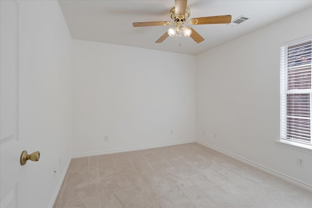 spare room featuring ceiling fan and light colored carpet