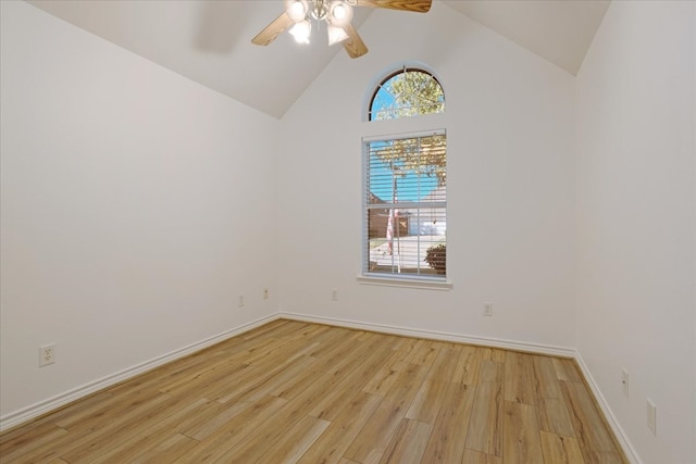 unfurnished room featuring ceiling fan, plenty of natural light, high vaulted ceiling, and light wood-type flooring