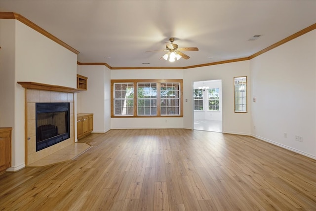 unfurnished living room with a tile fireplace, light wood-type flooring, ceiling fan, and ornamental molding