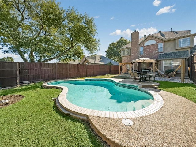 view of pool featuring a patio, a lawn, a fenced backyard, and a fenced in pool