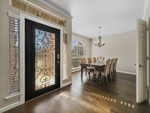 entryway featuring dark hardwood / wood-style flooring, ornamental molding, and a chandelier