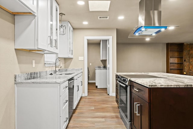 kitchen featuring exhaust hood, sink, appliances with stainless steel finishes, white cabinetry, and dark brown cabinetry