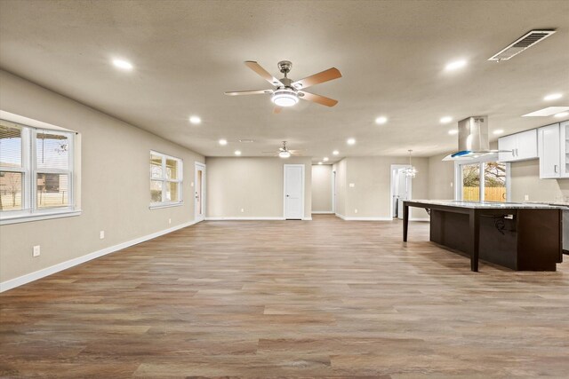 unfurnished living room featuring light hardwood / wood-style floors and ceiling fan