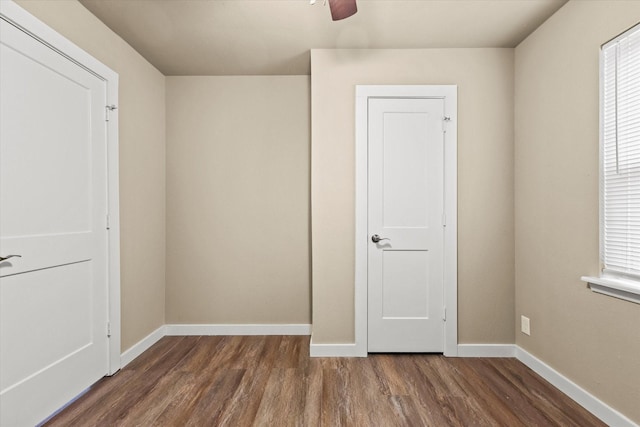 unfurnished bedroom with dark hardwood / wood-style flooring and ceiling fan