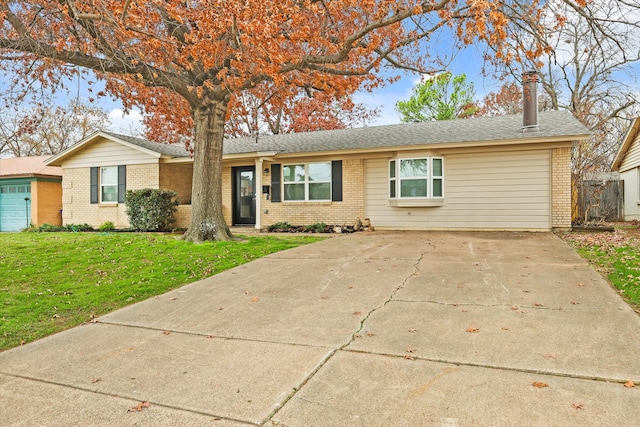 single story home featuring a garage and a front lawn