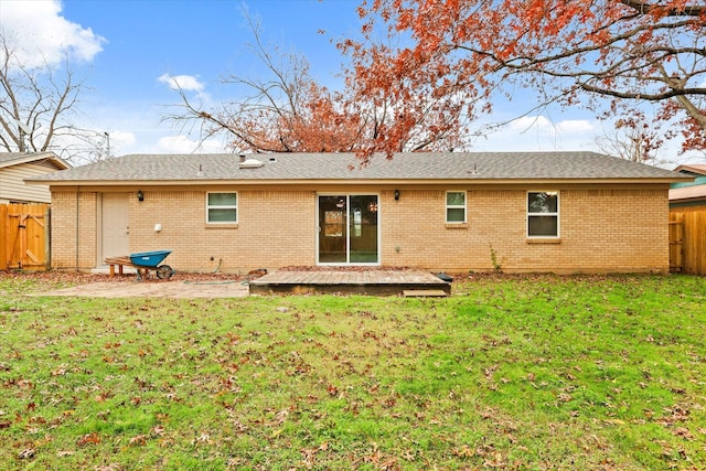 rear view of property with a yard