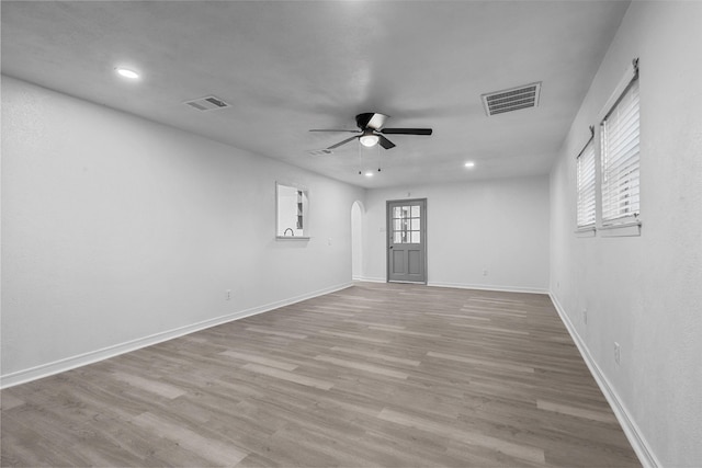 unfurnished room featuring light wood-type flooring and ceiling fan