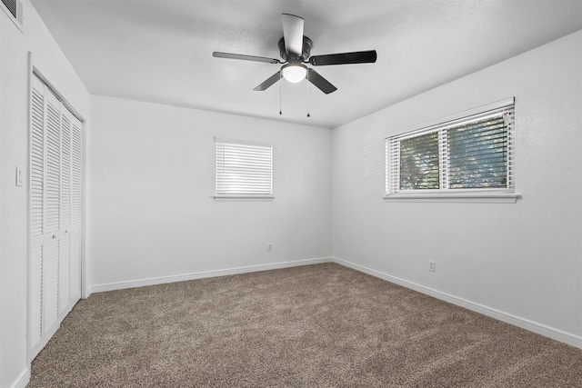 unfurnished bedroom featuring carpet flooring, a closet, and ceiling fan