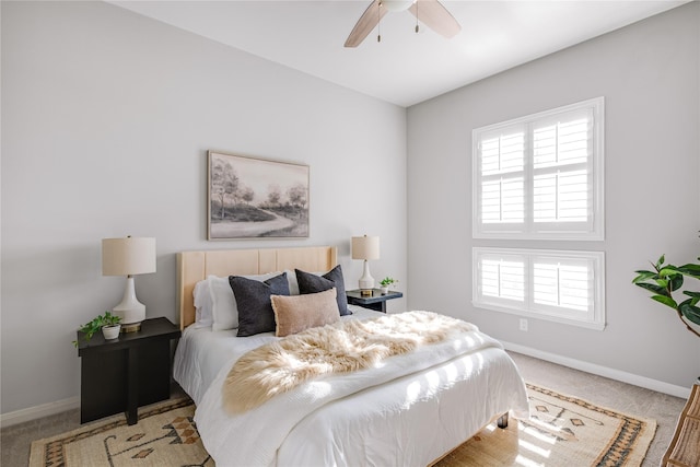 bedroom with ceiling fan and light carpet