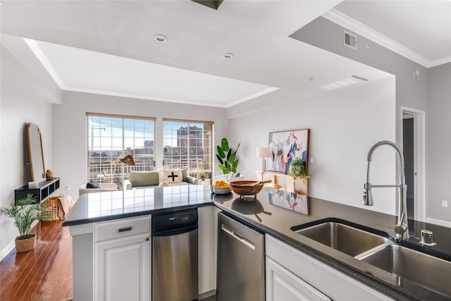 kitchen with white cabinets, crown molding, dishwasher, and sink