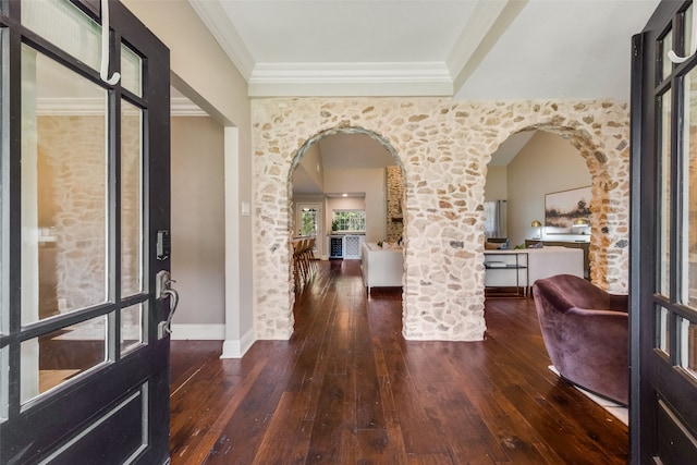 entrance foyer featuring dark hardwood / wood-style flooring and crown molding