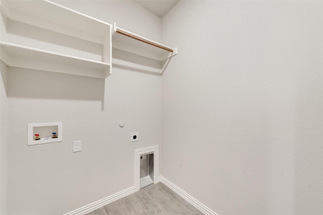 clothes washing area with washer hookup, light hardwood / wood-style floors, and electric dryer hookup