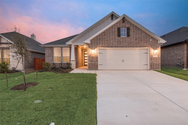 view of front of property featuring a garage and a yard