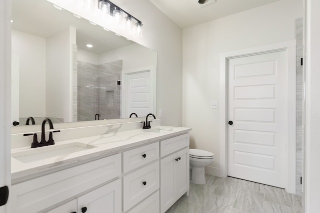 bathroom featuring vanity, an enclosed shower, and toilet