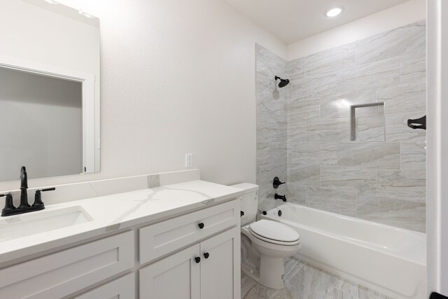 full bathroom with vanity, toilet, and tiled shower / bath