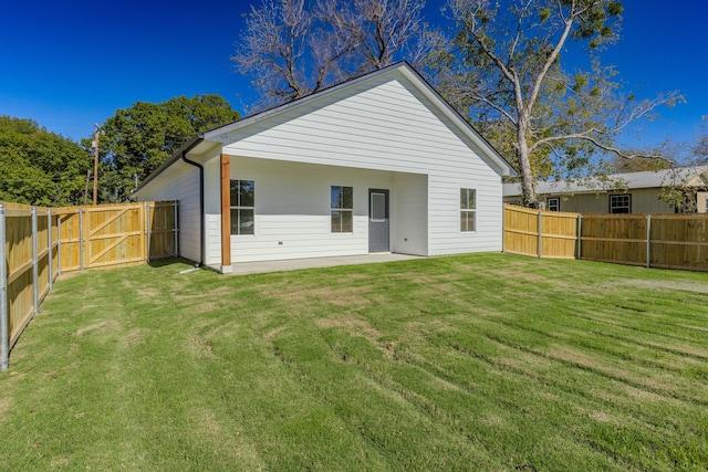 back of property featuring a lawn