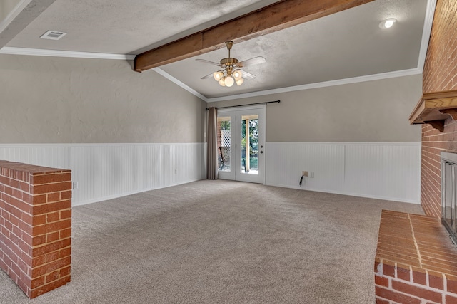 unfurnished living room with a textured ceiling, ceiling fan, carpet floors, and crown molding