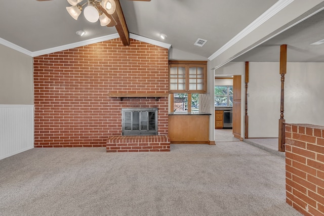 unfurnished living room with vaulted ceiling with beams, light carpet, a fireplace, and ceiling fan