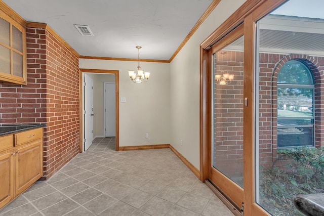 unfurnished dining area featuring ornamental molding and an inviting chandelier