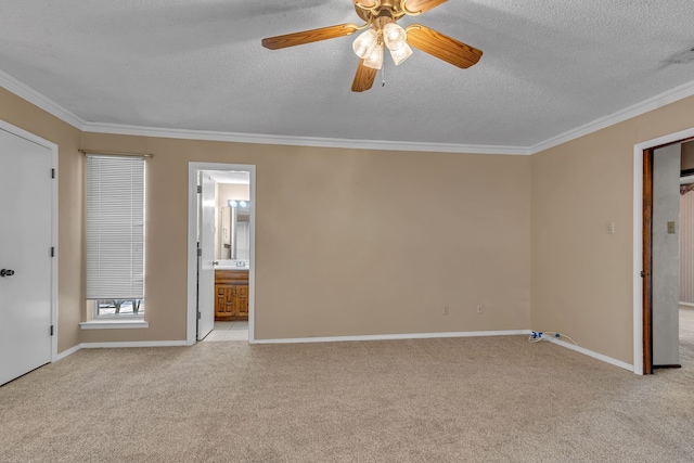 unfurnished bedroom with crown molding, ceiling fan, a textured ceiling, connected bathroom, and light colored carpet