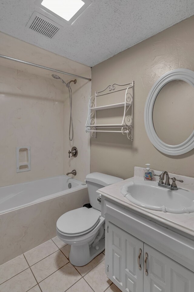 full bathroom featuring tile patterned flooring, a textured ceiling, vanity, and shower / bath combination