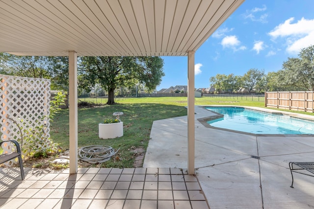 view of swimming pool with a lawn and a patio area