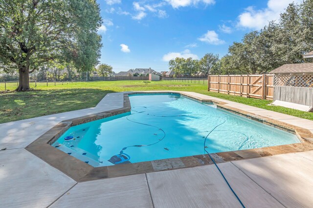 view of pool featuring a lawn